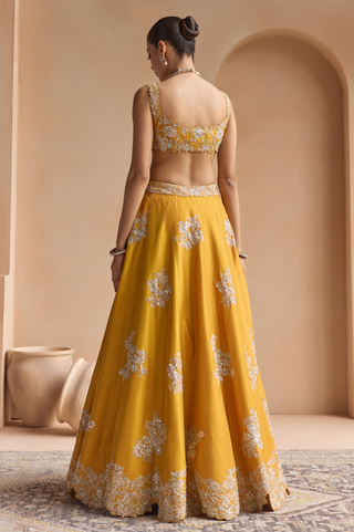 Back view of marigold blouse with scoop back and full skirt with scattered flower embroidery by Osaa by Adarsh at Mrs. G