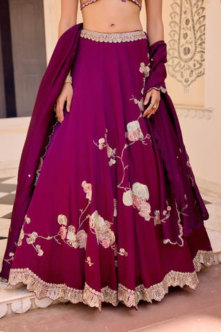 Close view of dark plum skirt with cream and pink flower branches and a scalloped zardozi hem by Osaa by Adarsh at Mrs. G