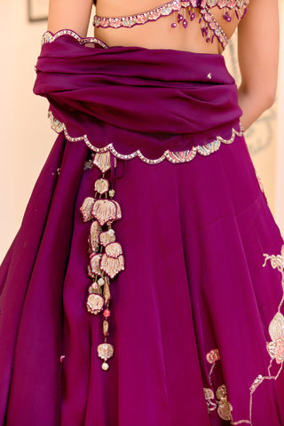 Back close view of dark plum lehenga waist with lotus tassel and scalloped dupatta edge by Osaa by Adarsh at Mrs. G