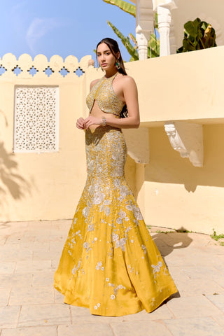 Three-quarter view of canary yellow fish cut lehenga flaring below the knee by Osaa by Adarsh at Mrs. G