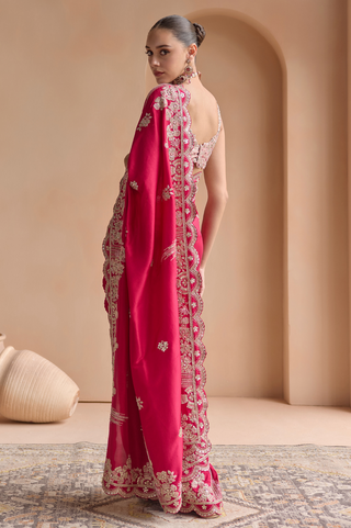Back view of chilli red saree with embroidered pallu border and scoop back blouse by Osaa by Adarsh at Mrs. G