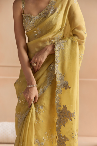 Close-up of butter yellow saree border with applique flowers, sequin clusters and scalloped edge by Osaa by Adarsh at Mrs. G
