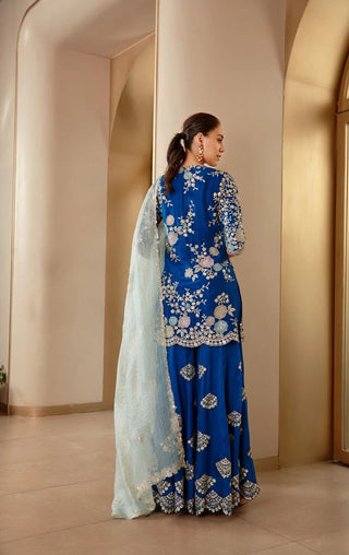 Back view of jade blue embroidered kurta with sharara and mint dupatta draped over the arms by Osaa by Adarsh at Mrs. G