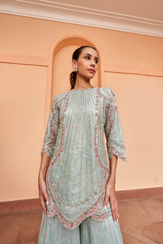 Portrait of pastel blue round-neck kurta with vertical sequin lines and scalloped cuffs by Osaa by Adarsh at Mrs. G