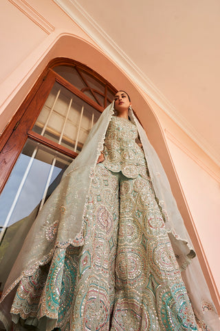 Low-angle view of cadet blue mandala sharara with organza dupatta draped over the head by Osaa by Adarsh at Mrs. G