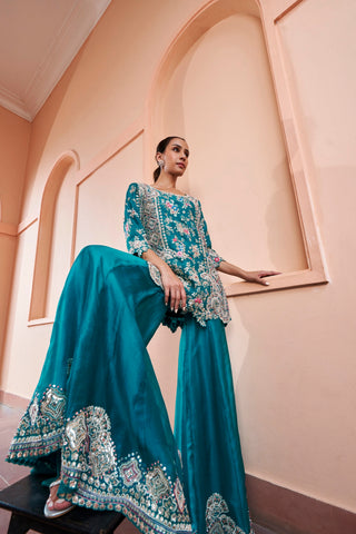 Side view of pine green sharara with embroidered hem border and floral kurta by Osaa by Adarsh at Mrs. G