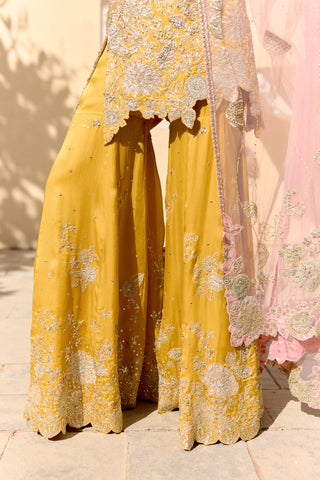 Close view of canary yellow wide sharara with floral patches and scalloped embroidered hem by Osaa by Adarsh at Mrs. G