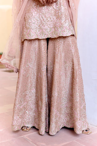 Close view of caramel taupe wide sharara with sequins, leaf motifs and an embroidered hem by Osaa by Adarsh at Mrs. G
