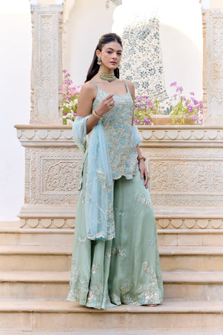 Front view of sage sharara set with a strappy zardozi kurta and pale blue net dupatta by Osaa by Adarsh at Mrs. G