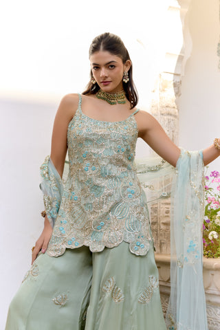 Waist-up view of sage scoop-neck kurta with gold lotus petals and aqua flower embroidery by Osaa by Adarsh at Mrs. G