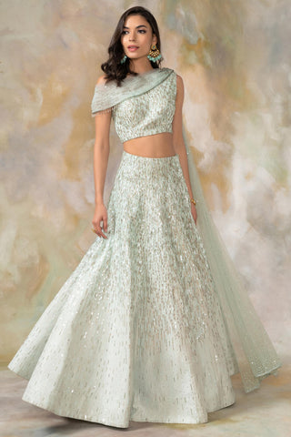 Light green one shouldered draped blouse and lehenga set