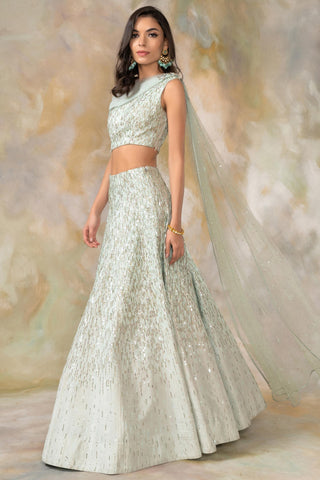 Light green one shouldered draped blouse and lehenga set