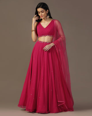 Bright pink draped blouse and lehenga set