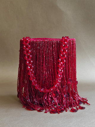 Red glamorous embellished potli with swaying tassels