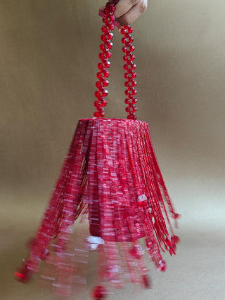 Red glamorous embellished potli with swaying tassels