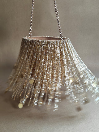 Gold embellished potli bag with swaying tassels