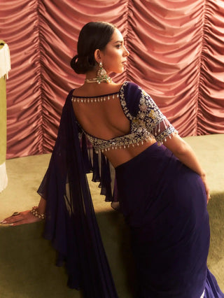 Back view of the purple ruffle saree with a deep-back choli and beaded strings at Mrs. G