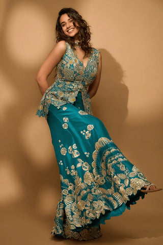 Front view of pine green peplum top with a low scooped back and a floral embroidered garara by Osaa by Adarsh at Mrs. G