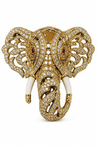 Flat product view of the gold zircon elephant brooch with ivory-tone tusks showing ivory-toned tusks and red stone eyes at Mrs. G