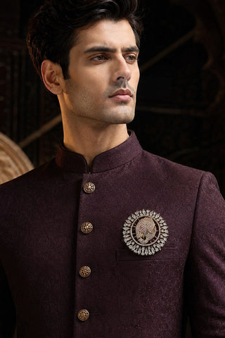 On-model view of the gold, white and pink zircon elephant brooch by Vivinia by Vidhi Mehra worn with a plum sherwani at Mrs. G