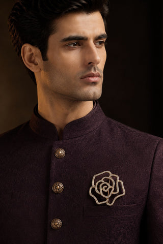 On-model view of the gold zircon floral brooch by Vivinia by Vidhi Mehra worn with a plum sherwani at Mrs. G