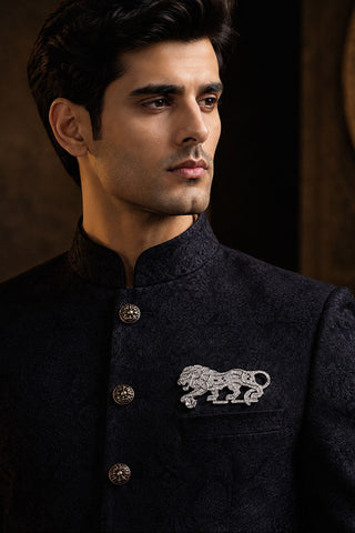 On-model view of the silver zircon lion brooch by Vivinia by Vidhi Mehra worn with a navy bandhgala at Mrs. G