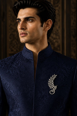 On-model view of the silver zircon leaf brooch by Vivinia by Vidhi Mehra worn with a navy sherwani at Mrs. G