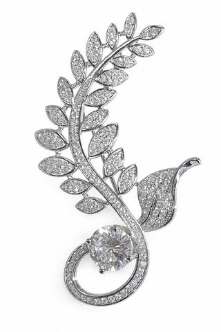 Flat product view of the silver zircon leaf brooch showing round center stone at the base at Mrs. G