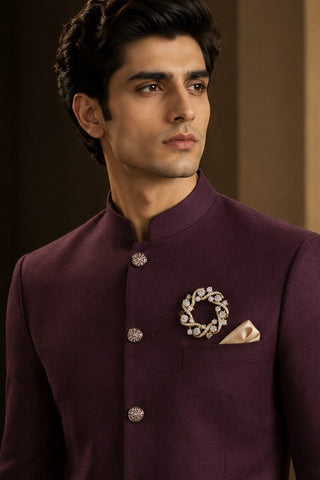 On-model view of the gold circular swirl zircon brooch by Vivinia by Vidhi Mehra worn with a plum sherwani at Mrs. G