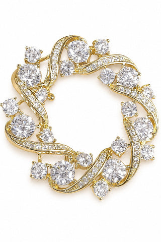 Flat product view of the gold circular swirl zircon brooch showing layered round zircon stones at Mrs. G