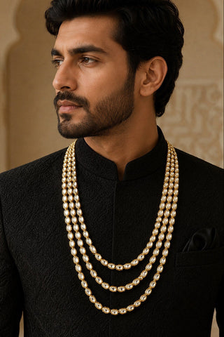 On-model view of the gold three-layer kundan groom mala by Vivinia by Vidhi Mehra worn with a black bandhgala at Mrs. G