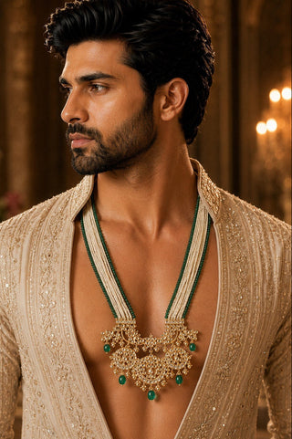 On-model view of the white pearl strand necklace with green bead drops and kundan pendant by Vivinia by Vidhi Mehra worn with a beige embroidered jacket at Mrs. G