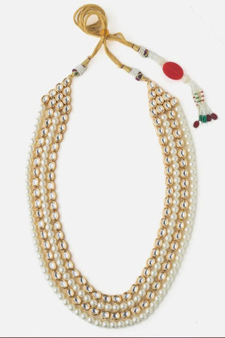 Flat product view of the white multi-layer pearl kundan mala showing adjustable golden cords with bead tassels at Mrs. G