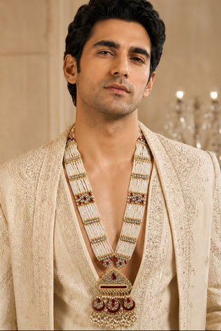 On-model view of the multicolor pearl strand kundan pendant necklace by Vivinia by Vidhi Mehra worn with a cream nehru jacket at Mrs. G