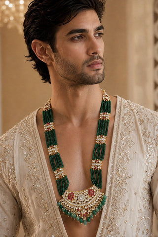 On-model view of the emerald green beaded kundan statement necklace with ruby accents by Vivinia by Vidhi Mehra worn with a cream embroidered open kurta at Mrs. G