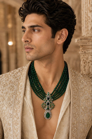 On-model view of the emerald green multi-layer beaded pendant necklace by Vivinia by Vidhi Mehra worn with a beige embroidered sherwani at Mrs. G