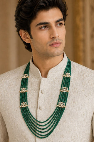 On-model view of the emerald green layered beaded kundan floral groom mala by Vivinia by Vidhi Mehra worn with a ivory sherwani at Mrs. G