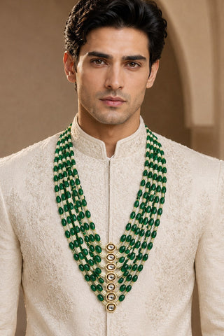On-model view of the emerald green layered beaded pearl kundan mala by Vivinia by Vidhi Mehra worn with a ivory sherwani at Mrs. G