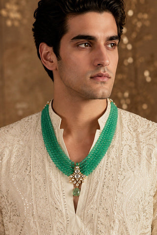 On-model view of the jade green beaded kundan pendant mala by Vivinia by Vidhi Mehra worn with a cream chikankari kurta at Mrs. G