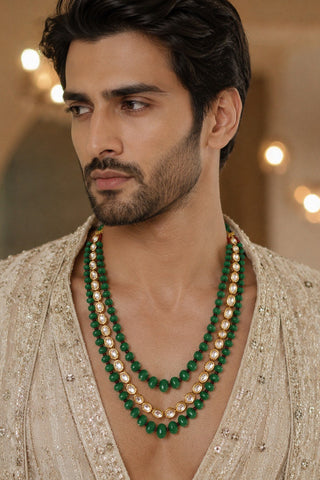 On-model view of the emerald green three-layer kundan beaded groom mala by Vivinia by Vidhi Mehra worn with a cream embroidered sherwani at Mrs. G