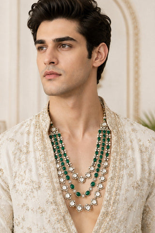 On-model view of the emerald green three-layer beaded kundan mala with tassel dori by Vivinia by Vidhi Mehra worn with a ivory embroidered jacket at Mrs. G