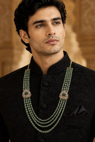On-model view of the sage green layered beaded kundan groom mala by Vivinia by Vidhi Mehra worn with a black bandhgala at Mrs. G