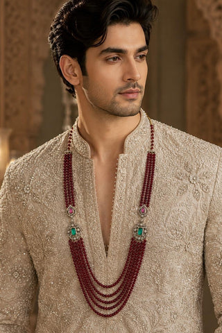 On-model view of the ruby red multi-layer beaded kundan groom mala by Vivinia by Vidhi Mehra worn with a beige embroidered kurta at Mrs. G
