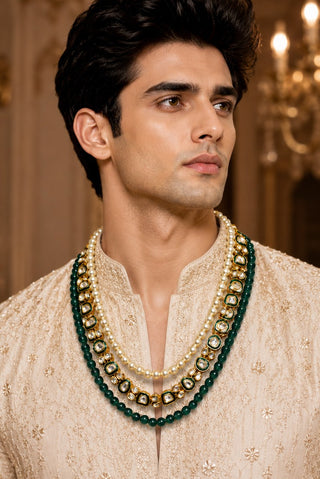 On-model view of the emerald green and gold three-layer pearl kundan groom mala by Vivinia by Vidhi Mehra worn with a beige embroidered kurta at Mrs. G