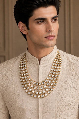 On-model view of the gold layered kundan groom mala with round stones by Vivinia by Vidhi Mehra worn with a cream sherwani at Mrs. G