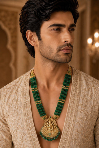 On-model view of the emerald green beaded temple pendant necklace by Vivinia by Vidhi Mehra worn with a beige kurta at Mrs. G