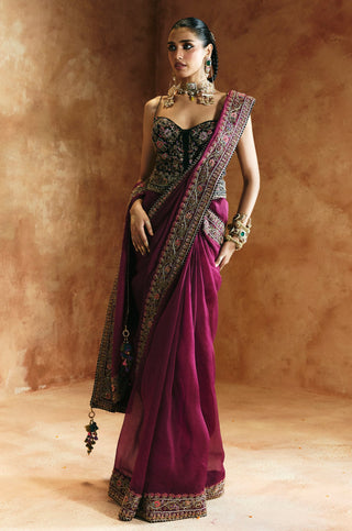 Full-length view of the black corset saree set with the pallu tassels falling to the hem by Aman Takyar at Mrs. G