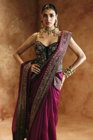 Waist-up front view of the black sweetheart corset blouse and embroidered pallu border by Aman Takyar at Mrs. G