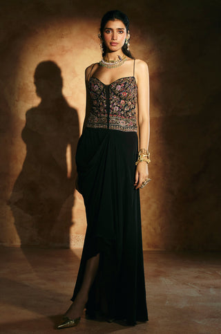 Front view of the black corset set with the skirt drape falling to one side by Aman Takyar at Mrs. G