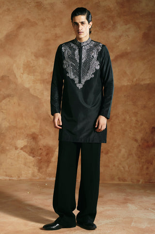 Full-length front view of the black kurta set with silver embroidered yoke and straight trousers by Aman Takyar at Mrs. G